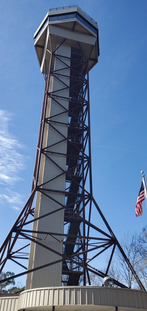 The Hot Springs National Park metal observation tower with a US flag flying beside it. 