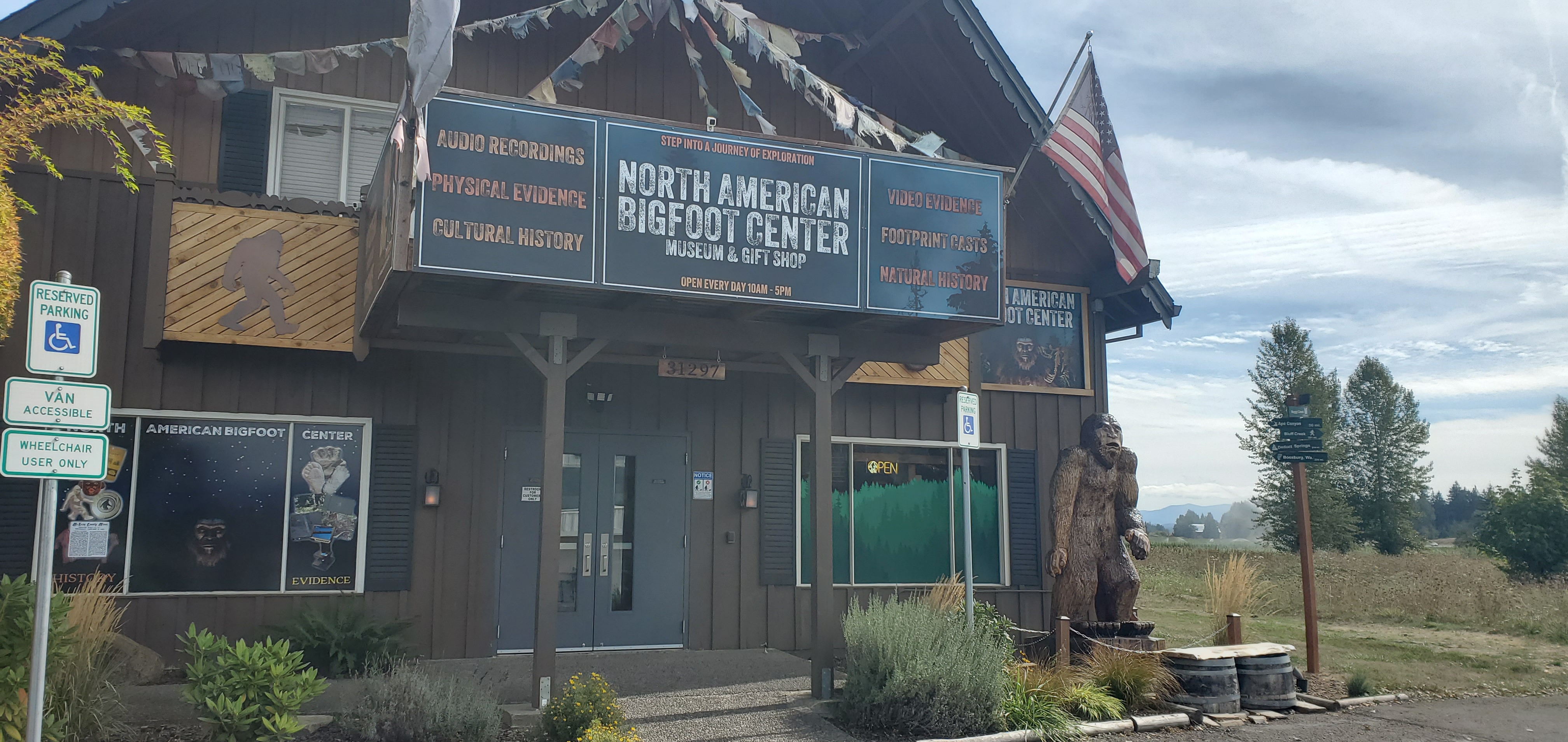 The exterior of a brown cabin building of the North American Bigfoot Museum.